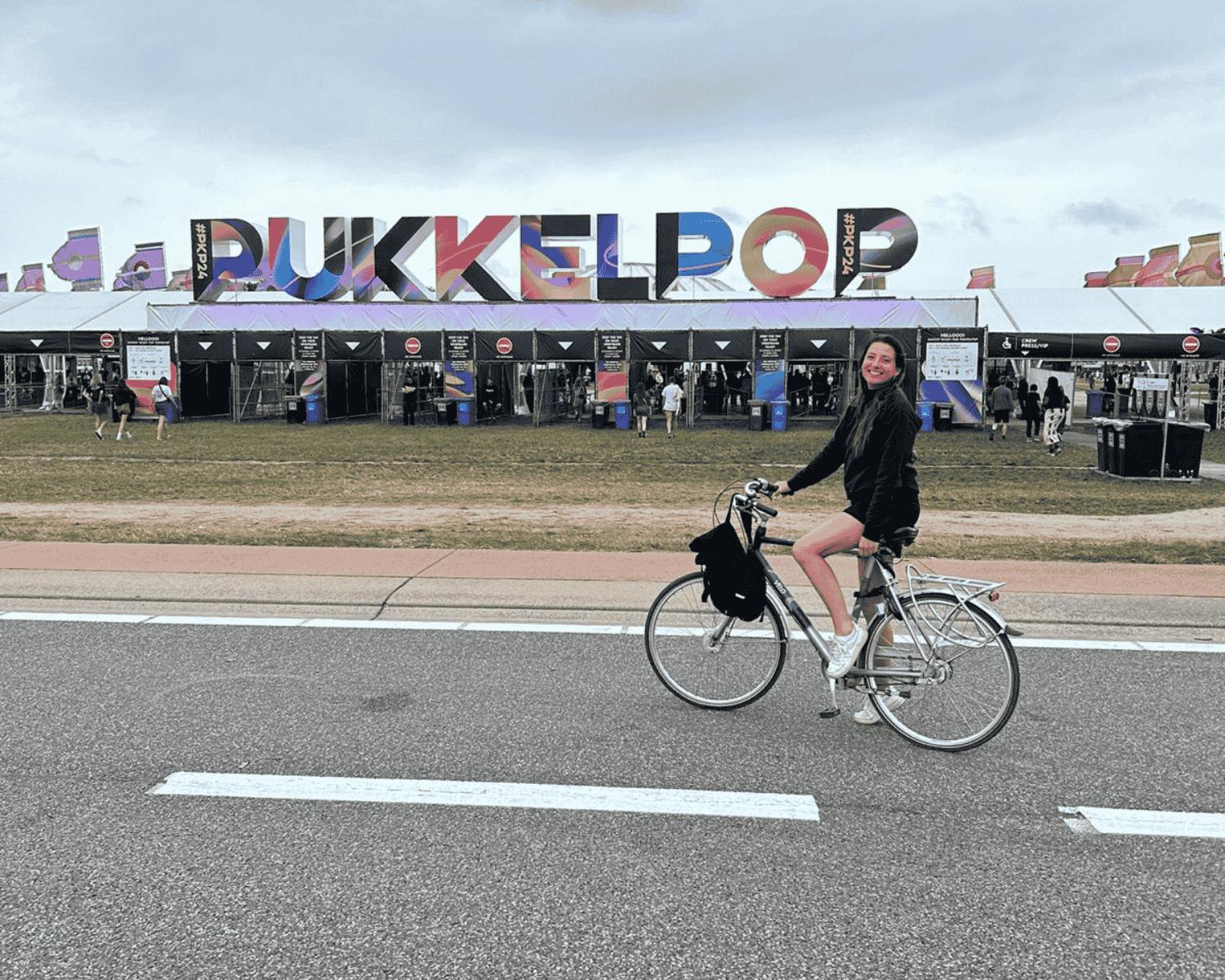 A cyclist riding past the Pukkelpop letters at the festival entrance