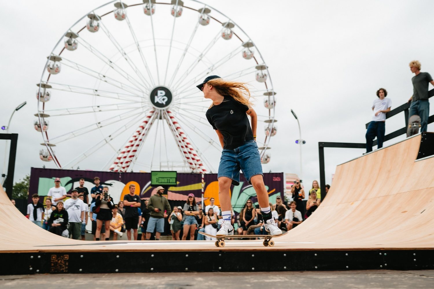 A skater on the festival’s half-pipe, with the Ferris wheel behind